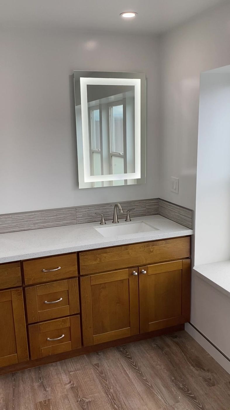 Double vanity with quartz counter and LED mirrors